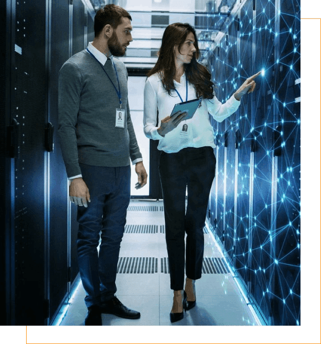 A man and woman in business attire are looking at the data center.